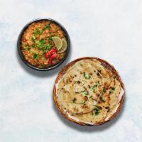 Baingan Bharta & Garlic Naan · Grilled eggplant minced and slowly cooked with tomatoes, onions, and herbs. Served with Indi...
