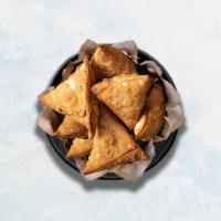 Samosa · Perfectly fried crispy pastry dumplings filled with a mix of aromatic herbs and mashed potat...