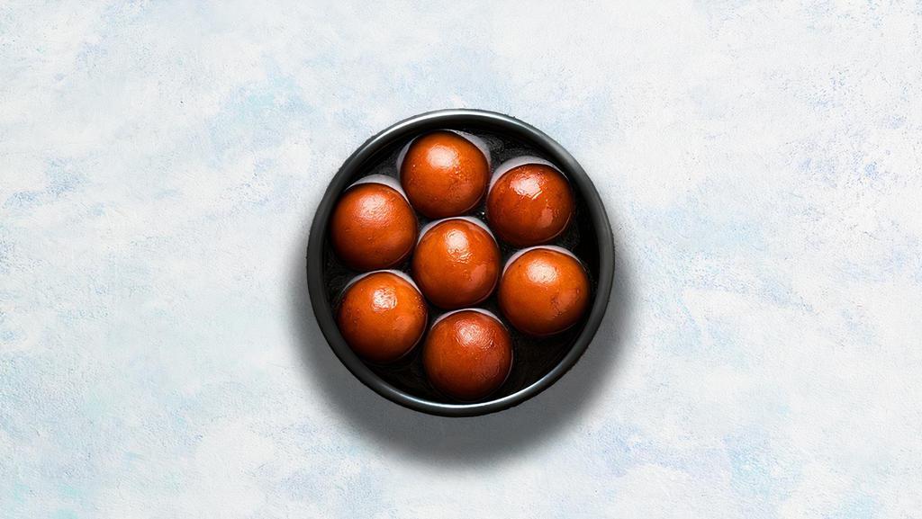 Gulab Jamun  · Soft berry-sized balls soaked in rose flavored sugar syrup.