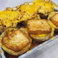 Mofonguitos · Fried plantain cups topped with your choice of meat, cheese, and drizzled with house made sa...