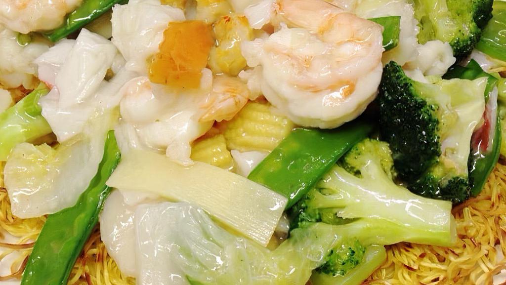 Seafood Pan Fried Noodle · Pan Fried Crispy Noodle topped with Jumbo Shrimp, Calamari, Scallop, Crabmeat and Vegetables