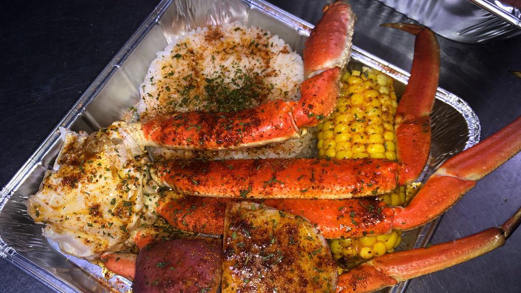 Seafood Boil · 2 clusters of delicious juicy Crab Legs in a tray with white rice, Sweet Corn , 2 potatoes , seasoned to perfection with butter sauce on the side