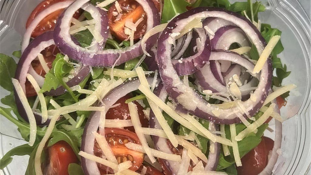 Arugula Salad · baby arugula, cherry tomatoes, red onions, grana padano, creamy balsamic dressing