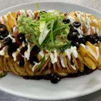 Twisted Nachos · Crispy twisted potatoes with melted cheddar cheese, black beans, tomatoes, olives, sour crea...