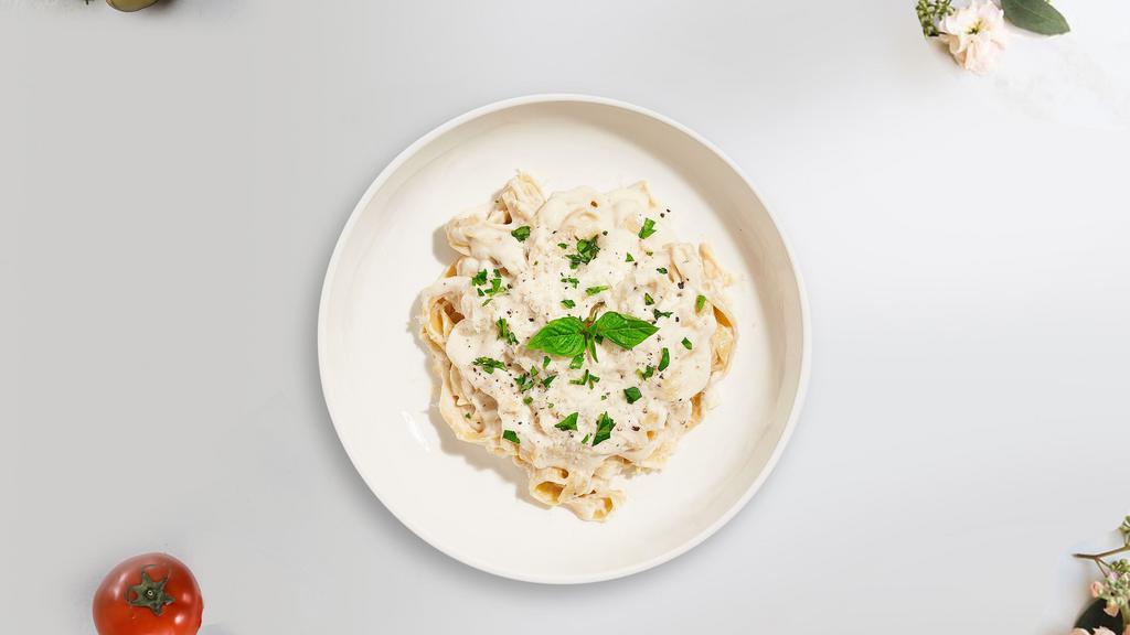 Alfredo Pasta · Fettuccine pasta cooked in creamy white sauce and aged parmesan. Served with bread.