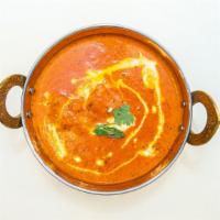 Butter Chicken · Clay oven baked chicken, cooked in rich tomato butter cream sauce.