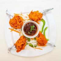 Chicken Lollipop · Succulent heavenly chicken drumsticks marinated with house spices and fried to perfection.