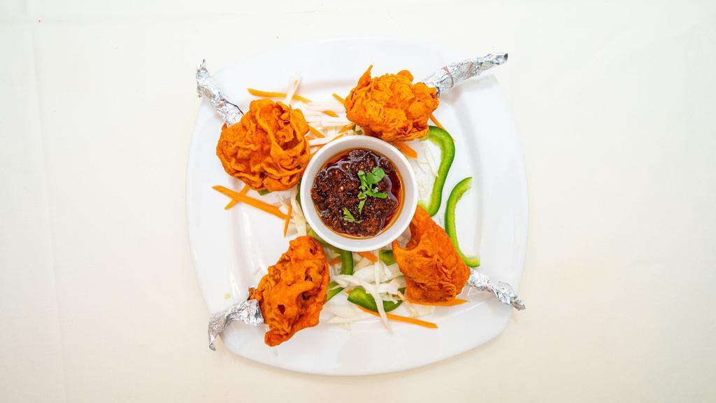 Chicken Lollipop · Succulent heavenly chicken drumsticks marinated with house spices and fried to perfection.