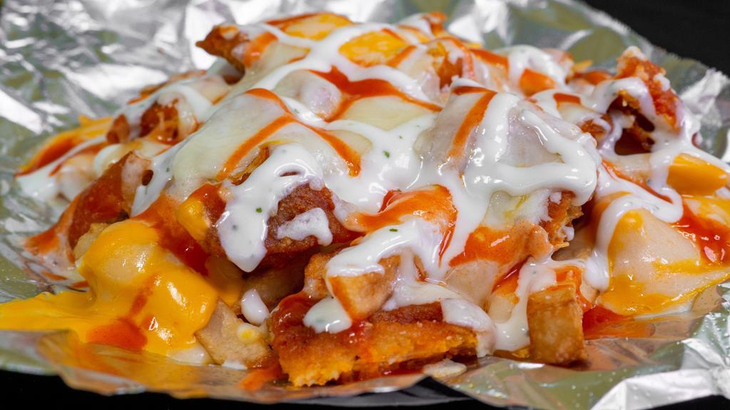 Buffalo Fries · Fried Chopped Buffalo Chicken Served With Melted Mozzarella & Nacho Cheese. Topped With Ranch & Buffalo Sauce.