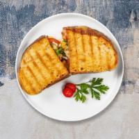 The Troisi Panini · Grilled chicken, fresh mozzarella, roasted peppers, and pesto on freshly baked bread. Served...