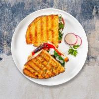 The Desica Panini · Breaded eggplant, roasted peppers, mozzarella, and caponata on freshly baked bread. Served w...