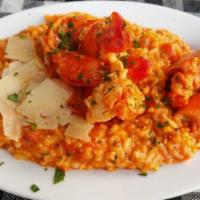 Γαρίδες Σαντορίνη / Shrimp Santorini · Sautéed shrimp with ouzo, tomato, onions, garlic, & feta served over rice.