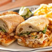 Fried Chicken Sandwich · Lettuce, tomato, pickles, and blue ribbon sauce. Served with pickled cucumbers and French fr...