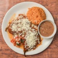 Chile Poblano Relleno · Two large green poblano peppers stuffed with chicken and topped with ranchero sauce and shre...