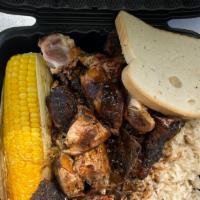 Jerk Chicken Platter · Jerk Chicken with rice, roasted corn, and hardough bread.