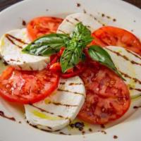 Caprese Salad · Homemade fresh mozzarella cheese, tomatoes, roasted red peppers, basil and extra virgin oliv...