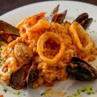 Risotto Pescatore · Mussels, shrimp, calamari and clams sautéed with garlic and white wine.