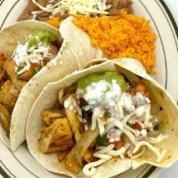 Fajitas Tacos Plattillo · 2 tacos on flour tortilla with rice and bean