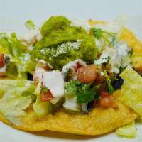 Tostadas · Deep fried round corn tortilla filled with refried beans topped with lettuce, pico de gallo,...
