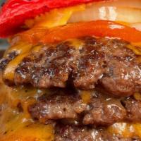 Triple Burger · 3 patties, lettuce, grilled tomato, onion, 1,000 island dressing, & cheddar Cheese