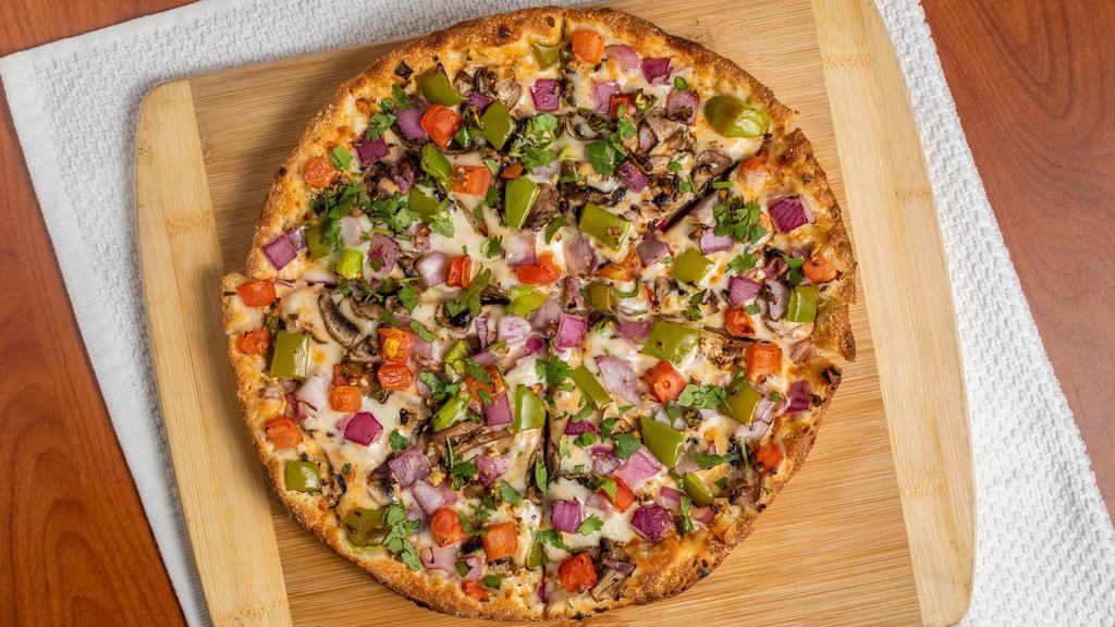 Tikka Masala Veggie Pizza Twist · This pizza has our signature tikka sauce, fresh diced mozzarella cheese, fresh mushrooms, crisp red onions, fresh bell peppers, juicy tomatoes, fresh cut; garlic, ginger & green chilies, garnished with fresh cilantro.