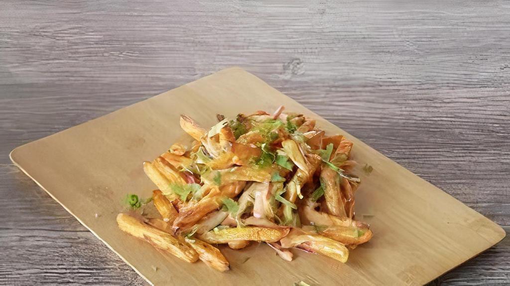 Masala Fries Twist · Our masala fries twist has sliced red onions, fresh-cut; garlic, ginger & Green chillies, tossed in our signature sauce, garnished with fresh cilantro.