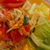 Papaya Salad (Som-Tum) · Thai famous papaya salad w/ tomato, string bean, peanuts & garlic in spicy chili lime dressing
