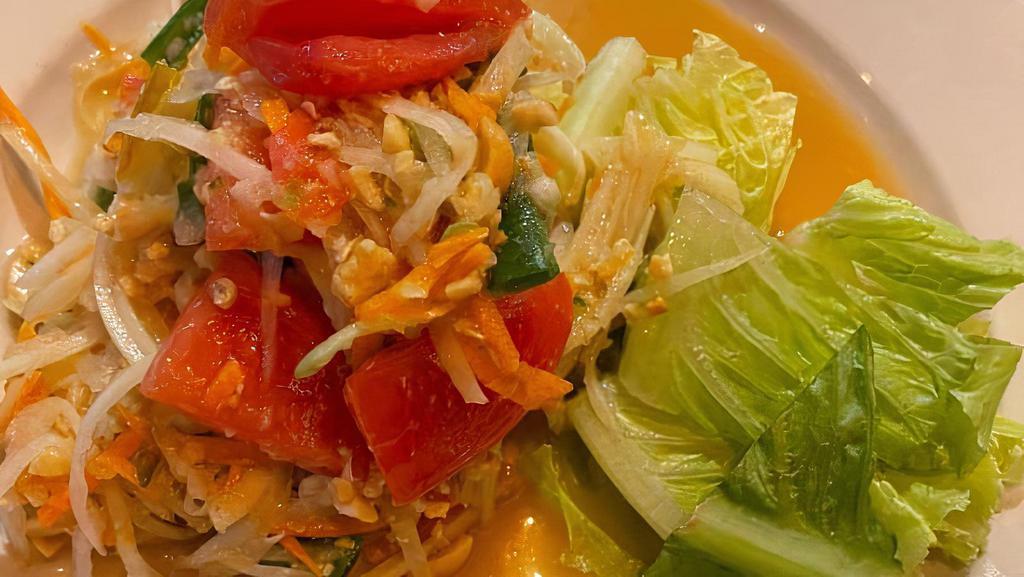 Papaya Salad (Som-Tum) · Thai famous papaya salad w/ tomato, string bean, peanuts & garlic in spicy chili lime dressing