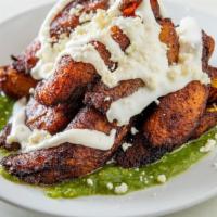 Plantains · Sweet plantains served veracruz style with salsa verde and queso fresco. sweet tangy and spi...