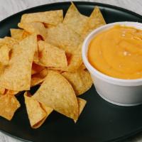 Chips & Spicy Nacho Cheese.  · Crunchy Tortilla Chips and 8oz Spicy Nacho Cheese.