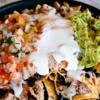 Nachos · Tortilla Chips, Beans, Choice of any Meat, Melted Mozzarella, Topped with Pico de Gallo, Sou...