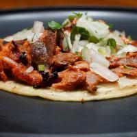Un Taco · One Corn Tortilla Taco with Choice of Al Pastor, Carnitas, or Chicken, Topped with Onions an...
