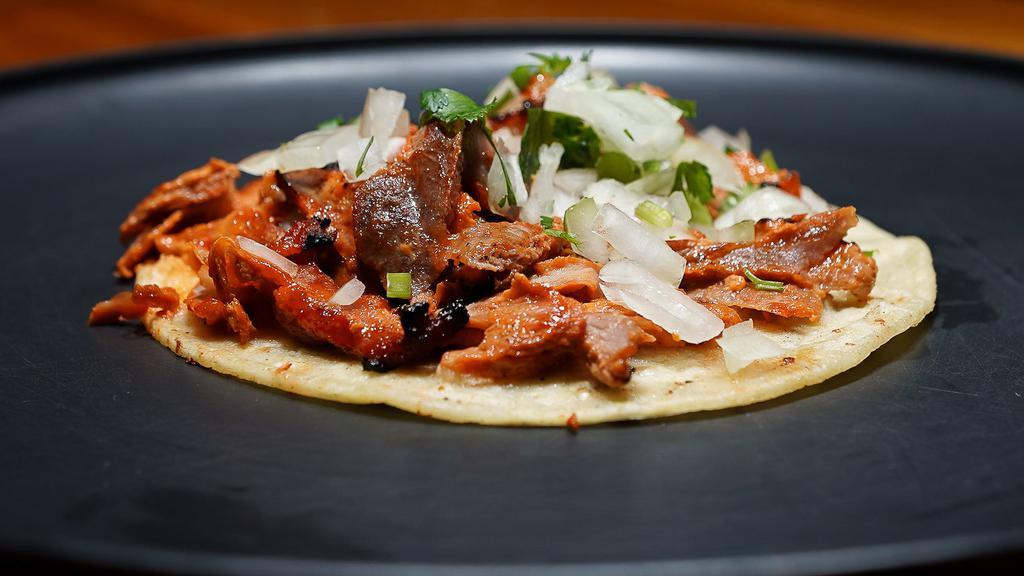 Un Taco · One Corn Tortilla Taco with Choice of Al Pastor, Carnitas, or Chicken, Topped with Onions and Cilantro.