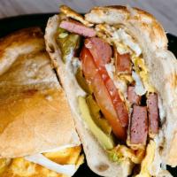 Cubana · A Mexican Style Sandwich with Mayo, Avocado, Tomato, Pickled Jalapenos, Ham, Breaded Pork Ch...