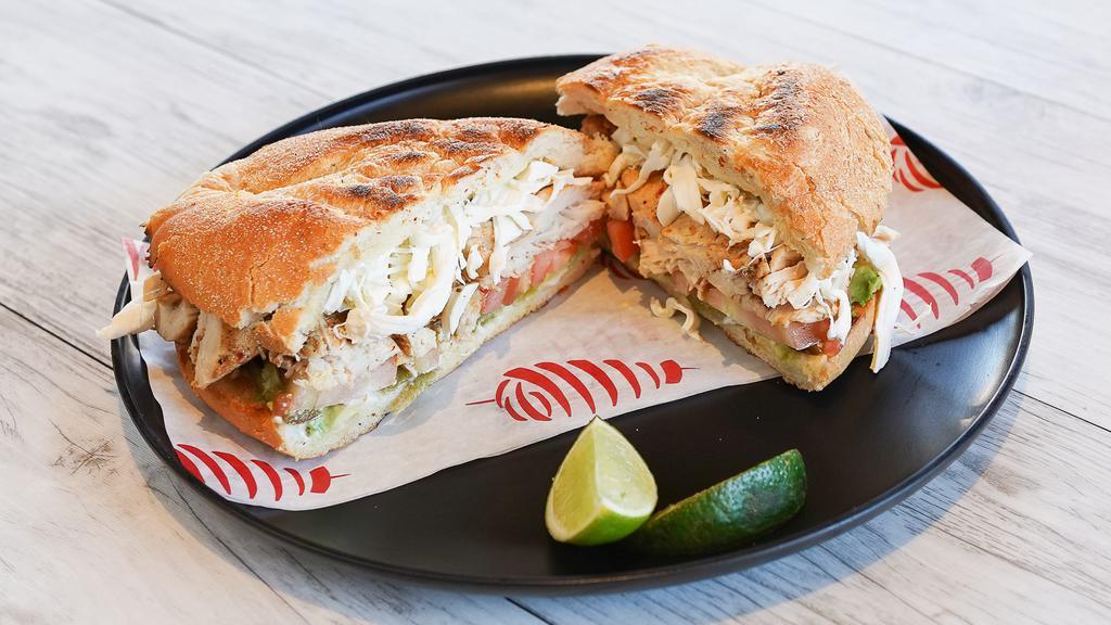 Torta De Pollo · A Mexican Style Sandwich with Mayo, Avocado, Tomato, Pickled Jalapenos, Chicken, and Mozzarella Cheese.