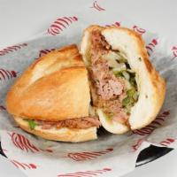 Torta Carnitas · A Mexican Style Sandwich with Avocado, Carnitas, Onions, and Cilantro.