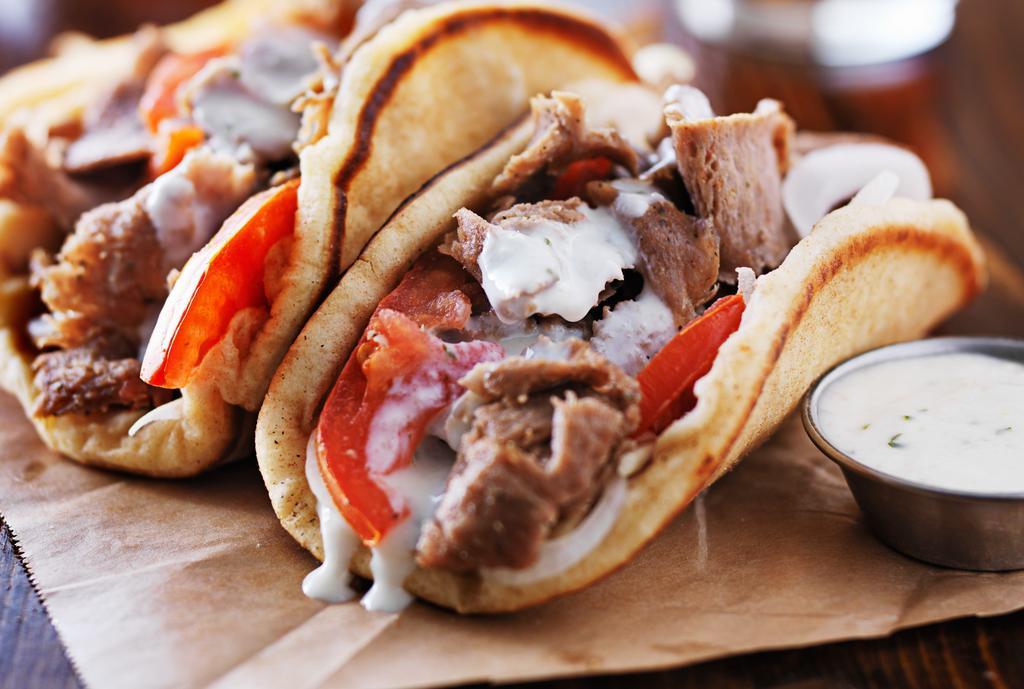 Gyro · Slow roasted spiced meat dressed with lettuce, tomato, onion, and tzatziki sauce on pita bread.
