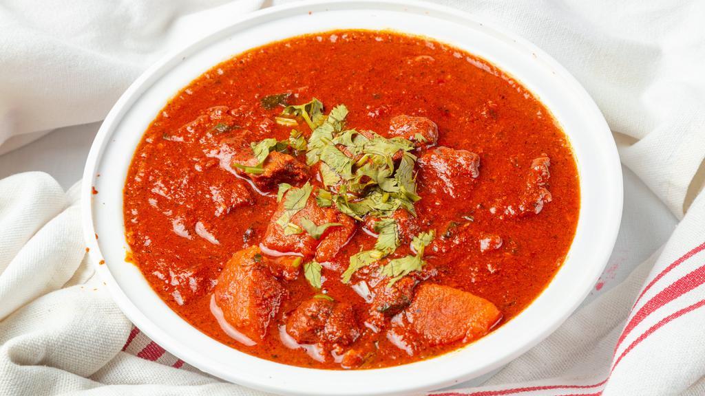 Vindaloo (Spicy Curry) · Your Choice  in a spicy curry. Side of basmati rice & raita. Spicy!