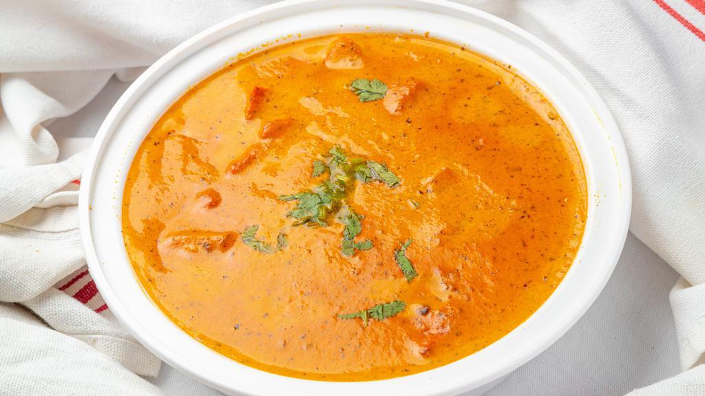 Chicken Tikka Masala · Tender boneless chicken grilled in Tandoor and then cooked in thick tomato, green pepper, onion and cream sauce. Served with basmati rice & raita.