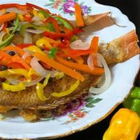 Escovitch  Snapper Fish  · Fry Fish topped with spicy carrot and onion sauce with 2 sides.
