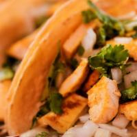 Chicken Tacos Order (3) · Three Tacos topped with fresh onions and cilantro garnish with lime wedge and radish accompa...