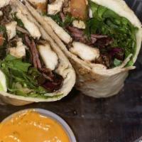 The Chicken Club Wrap · Grilled Chicken, Turkey Bacon, Fresh Mozzarella, Mixed Greens, Tomato and ranch dressing.