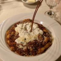 Gnocchi · small dumplings made from potatoes, served with da Nina's meat sauce topped with ricotta che...