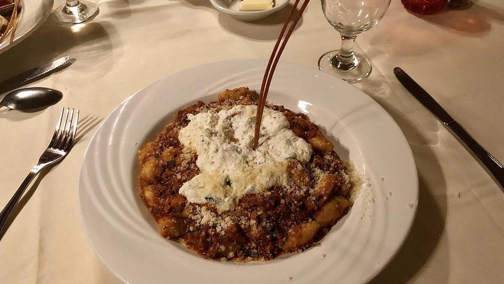 Gnocchi · small dumplings made from potatoes, served with da Nina's meat sauce topped with ricotta cheese.