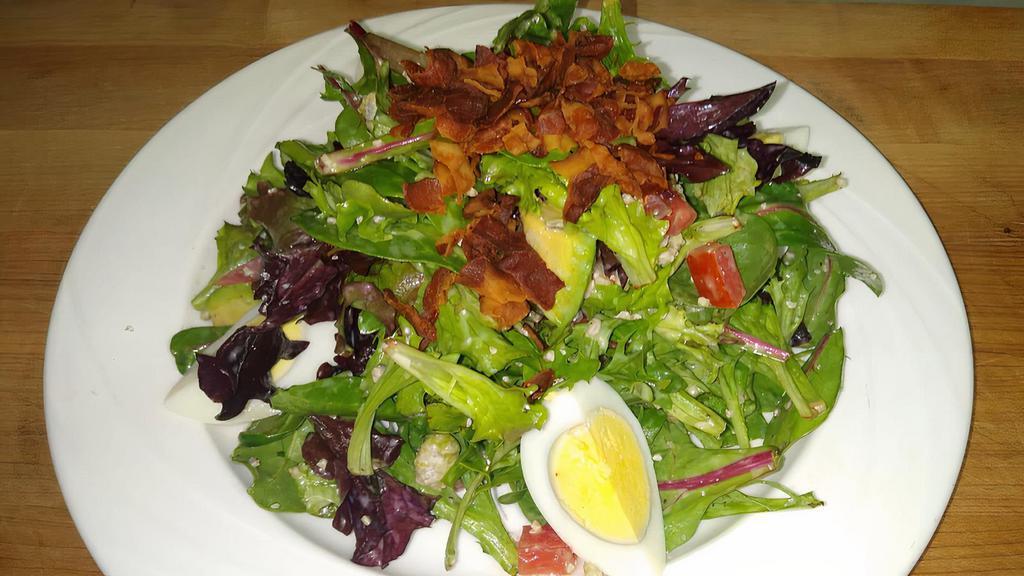 Cobb Salad  · Mesclun greens, tomatoes, crispy bacon, hard boiled eggs, avocados, crumbled blue cheese and Dijon dressing