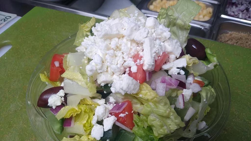 Greek Salad  · Romaine lettuce, tomatoes, red onion, cucumber, imported feta cheese, kalamata olives, with Dijon dressing