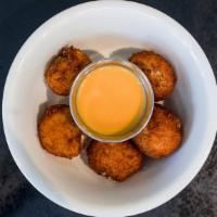 Jalapeno Poppers · 5 creamy, spicy and crunchy fried poppers with a side of cheese sauce