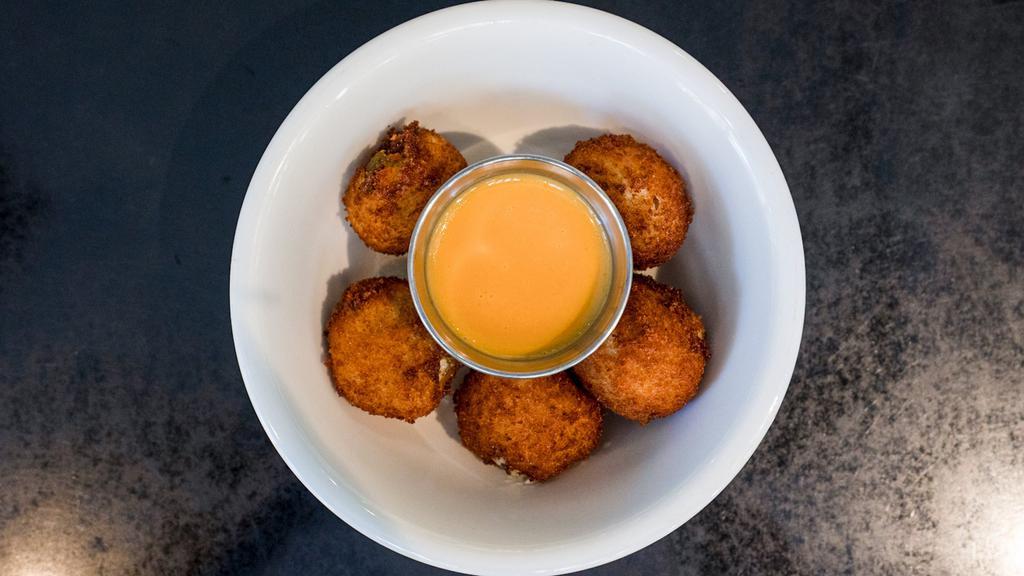 Jalapeno Poppers · 5 creamy, spicy and crunchy fried poppers with a side of cheese sauce