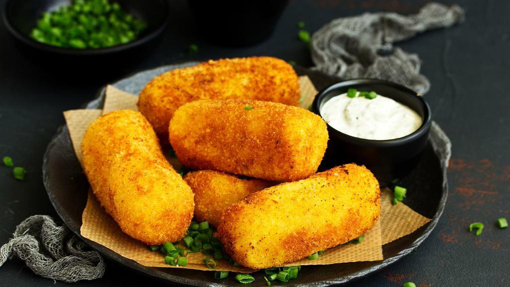 Potato Croquettes · Deep-fried croquette stuffed with potatoes, bacon and cheese.