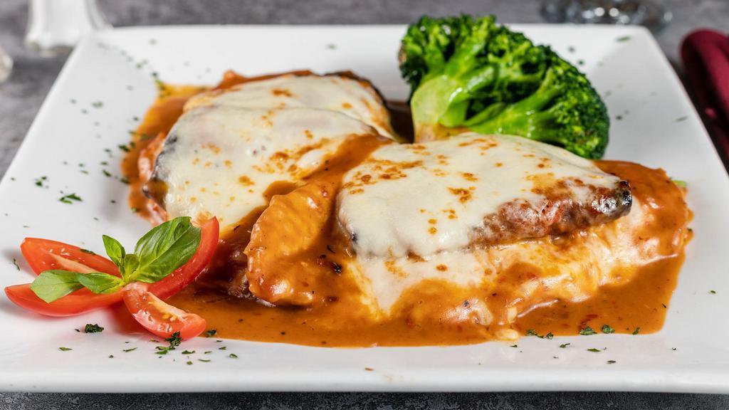 Entrée Sorrentino · Chicken or veal layered with sliced prosciutto, battered eggplant, and melted mozzarella in a light marsala sauce.
